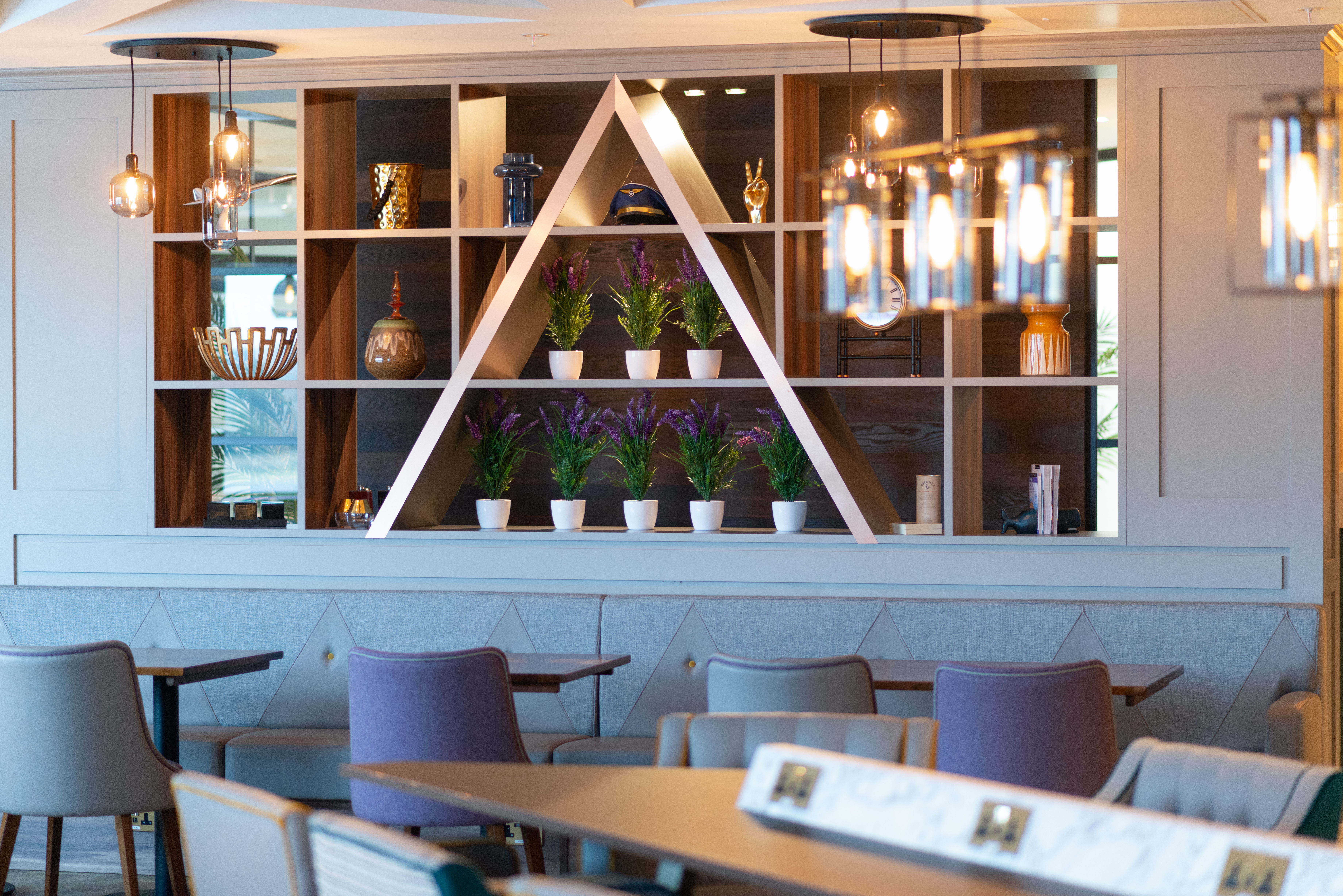 Decorative wall with the Aspire 'A' emblem in the Edinburgh Gate 16 Aspire Lounge