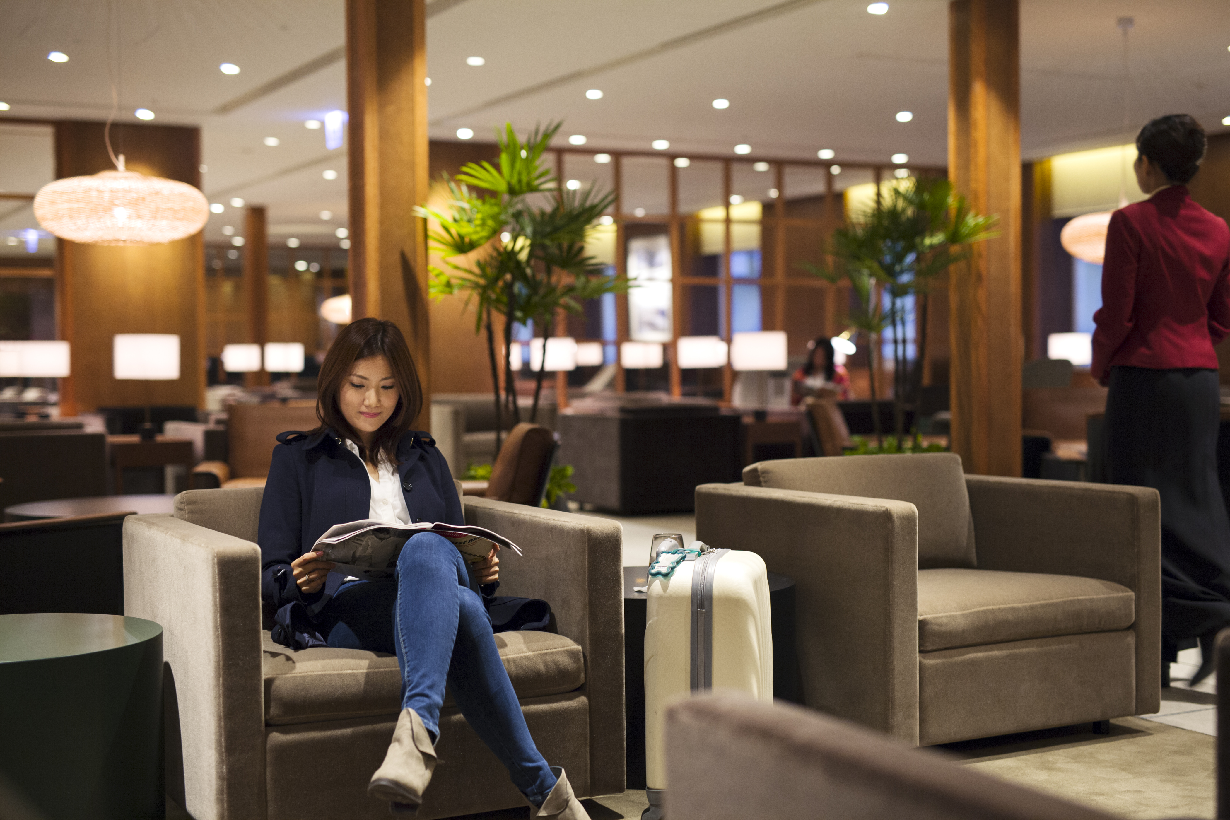 Woman sitting in a comfortable chair in a lounge.